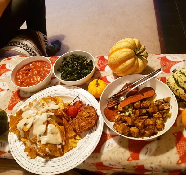 Homemade snacks. Crispy kale, bacon and seasoned chicken, cheese and 'pulled pork' topped nachos